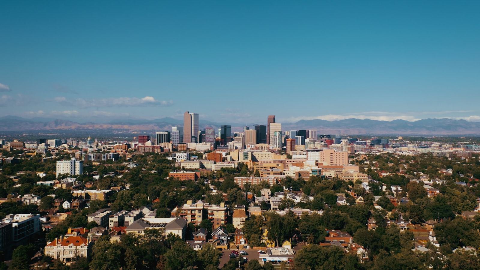 Tree-lined neighborhoods with the skyline and the Front Range beyond